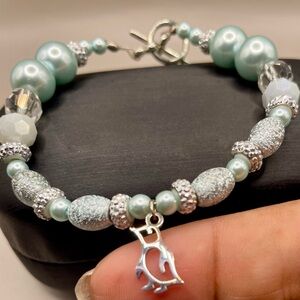 Blue bead and crystal toggle closure bracelet with a silver penguin charm. Cute